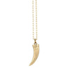 Gold tusk pendant necklace on a white background