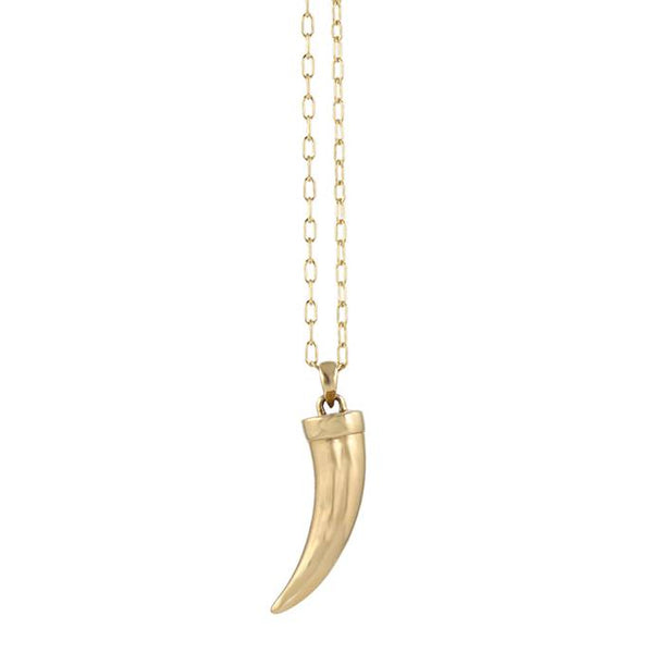 Gold tusk pendant necklace on a white background