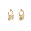 Gold hoop earrings with peach beads on a white background