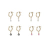 Set of gold hoop earrings with various colored drop pendants on a white background