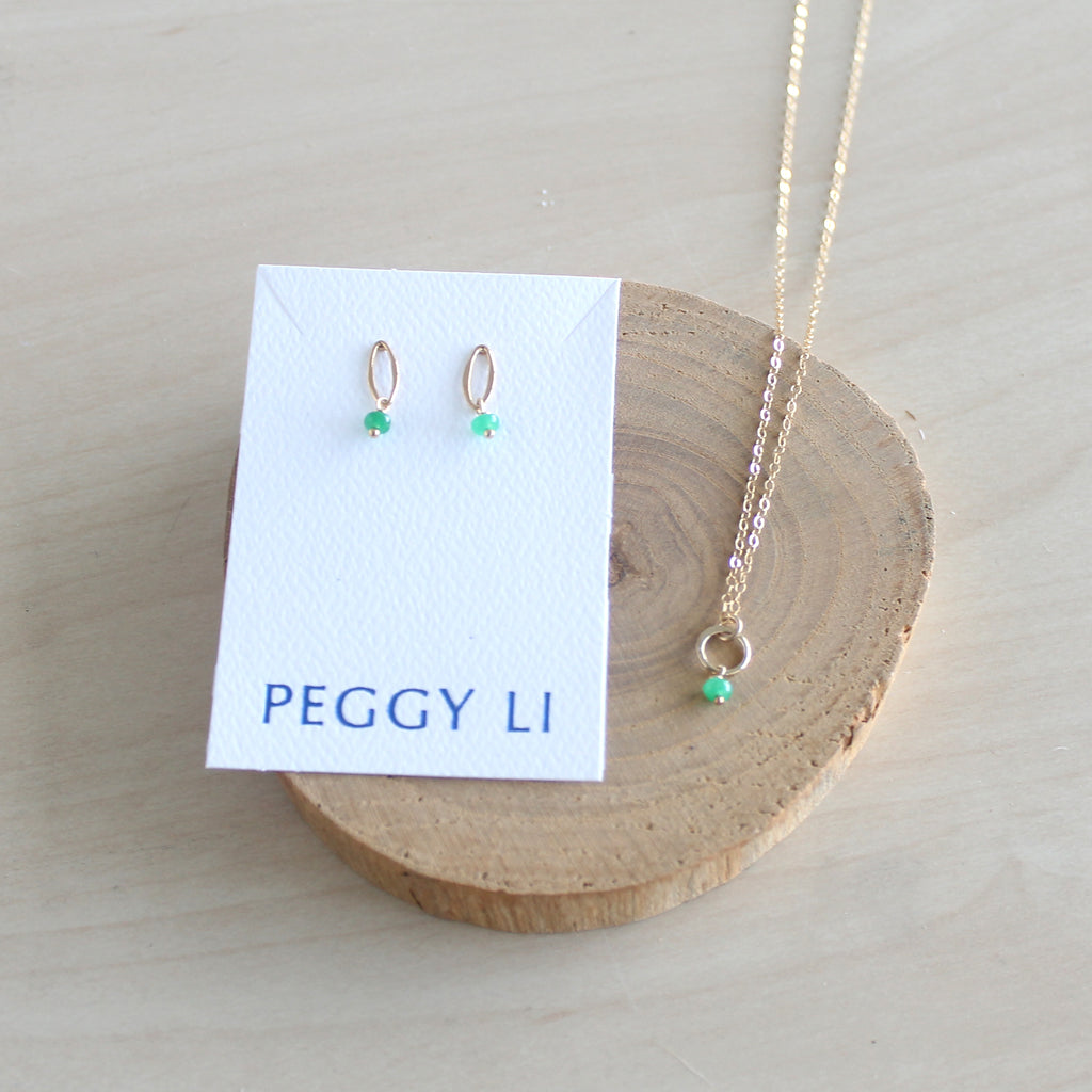 Jade jewelry set with necklace and earrings on a Peggy Li card