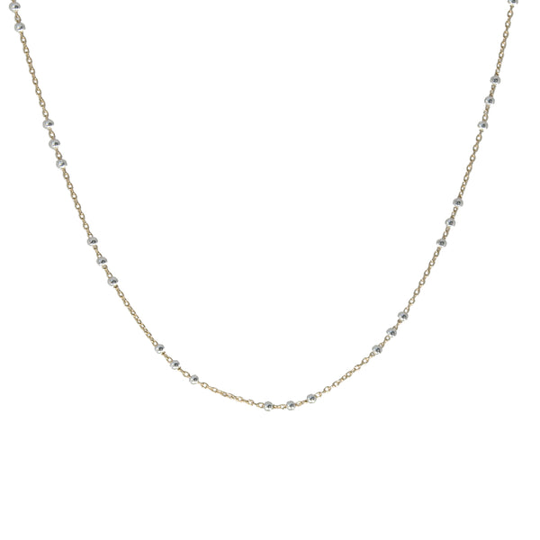 A delicate gold chain necklace with small, evenly spaced silver-toned bead accents, displayed against a solid white background.