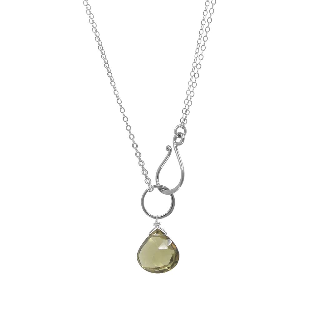 Necklace with a teardrop-shaped green gemstone pendant on a white background
