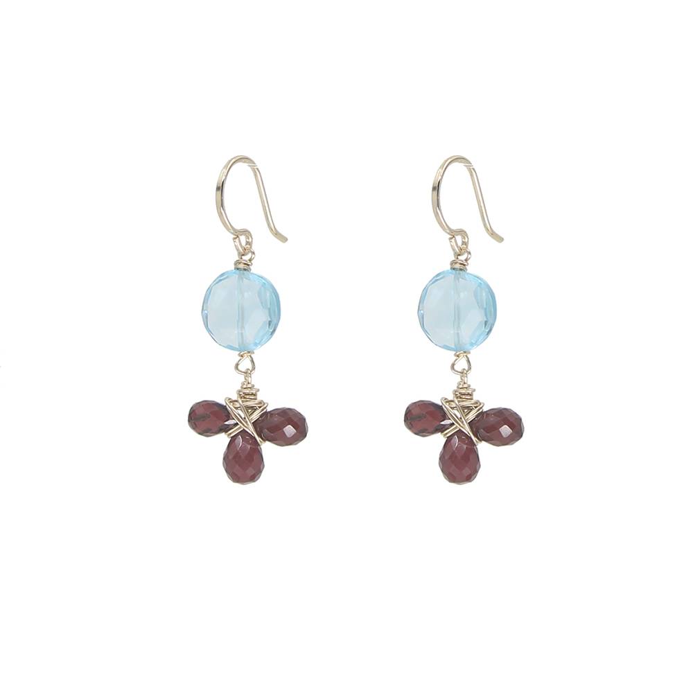 Pair of earrings with blue gemstones and red beads on a white background