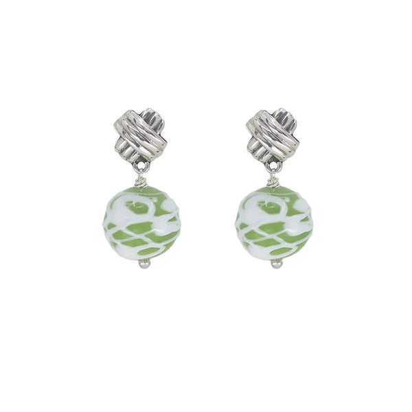 Pair of earrings with green and white floral patterns on a white background