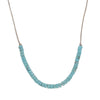 Turquoise beaded necklace on leather cord on a white background