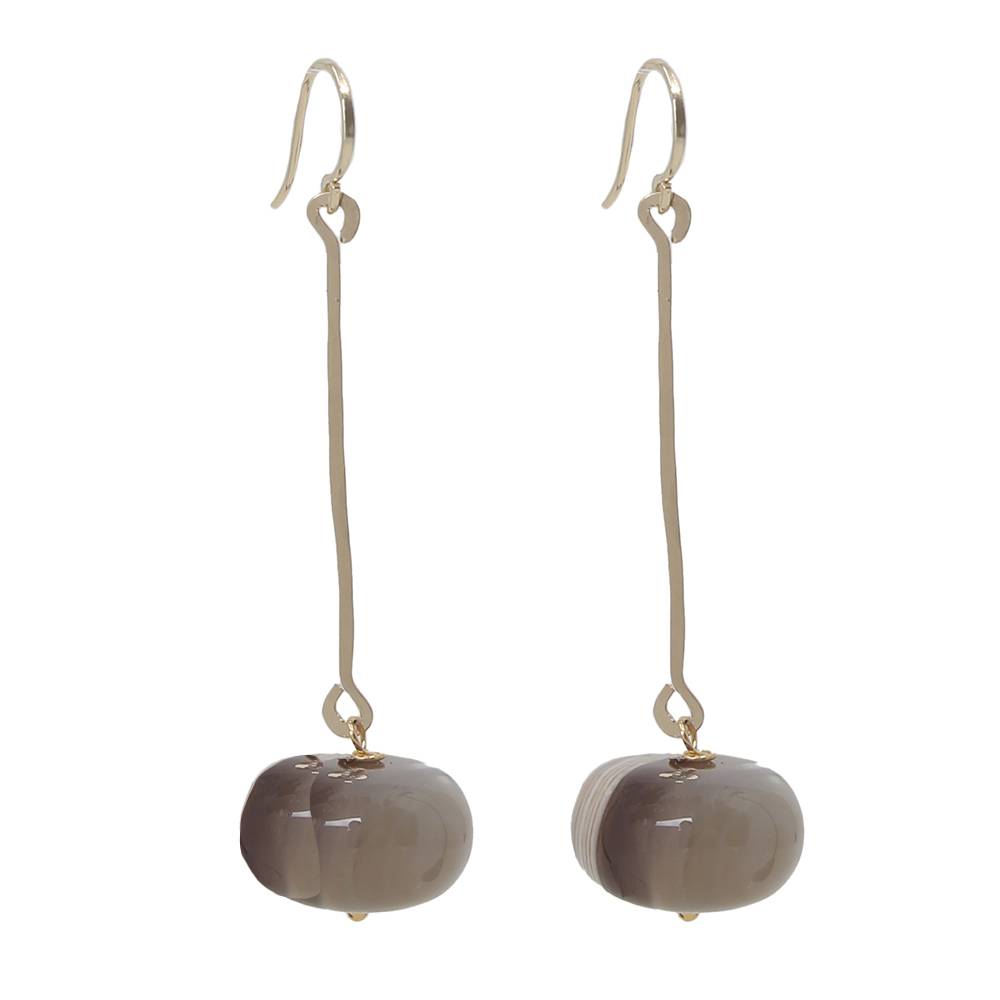Pair of earrings with round beige stones on a white background