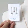Asymmetrical earrings with pearl