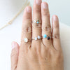 Assorted gemstone rings on hand